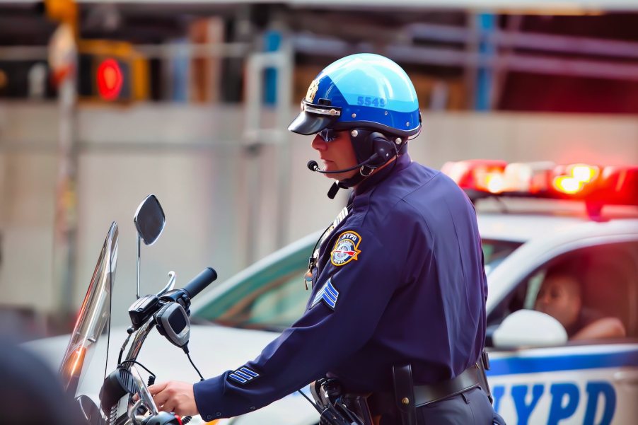Police officer on a motorcycle enforcing traffic laws.