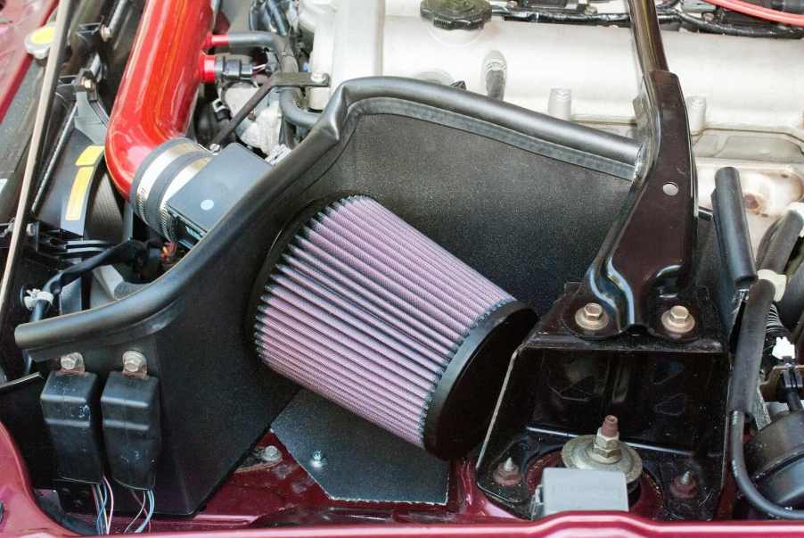 Cold air intake under the hood of a performance vehicle.