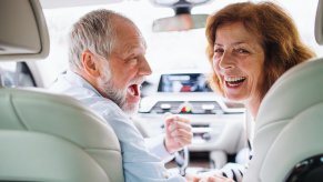 Happy couple driving their 2025 SUV