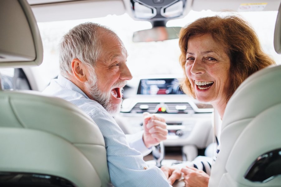 Happy couple driving their 2025 SUV