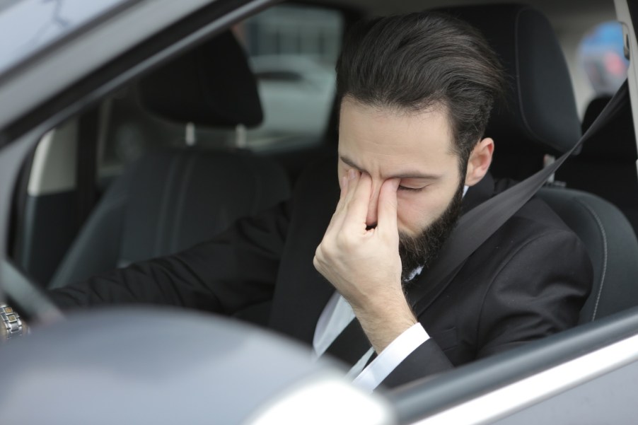 Driver with his head in his hands after getting OWI at Michigan police station