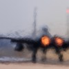 F-15D fighter taxis onto the runway, its jet engines glowing.
