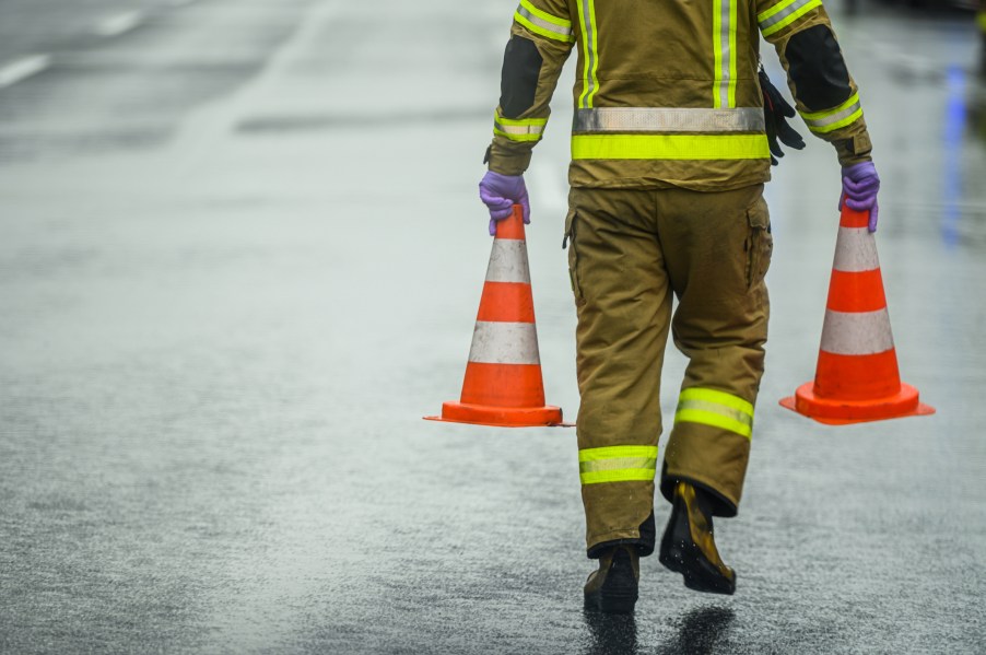 A firefighter walking on the road