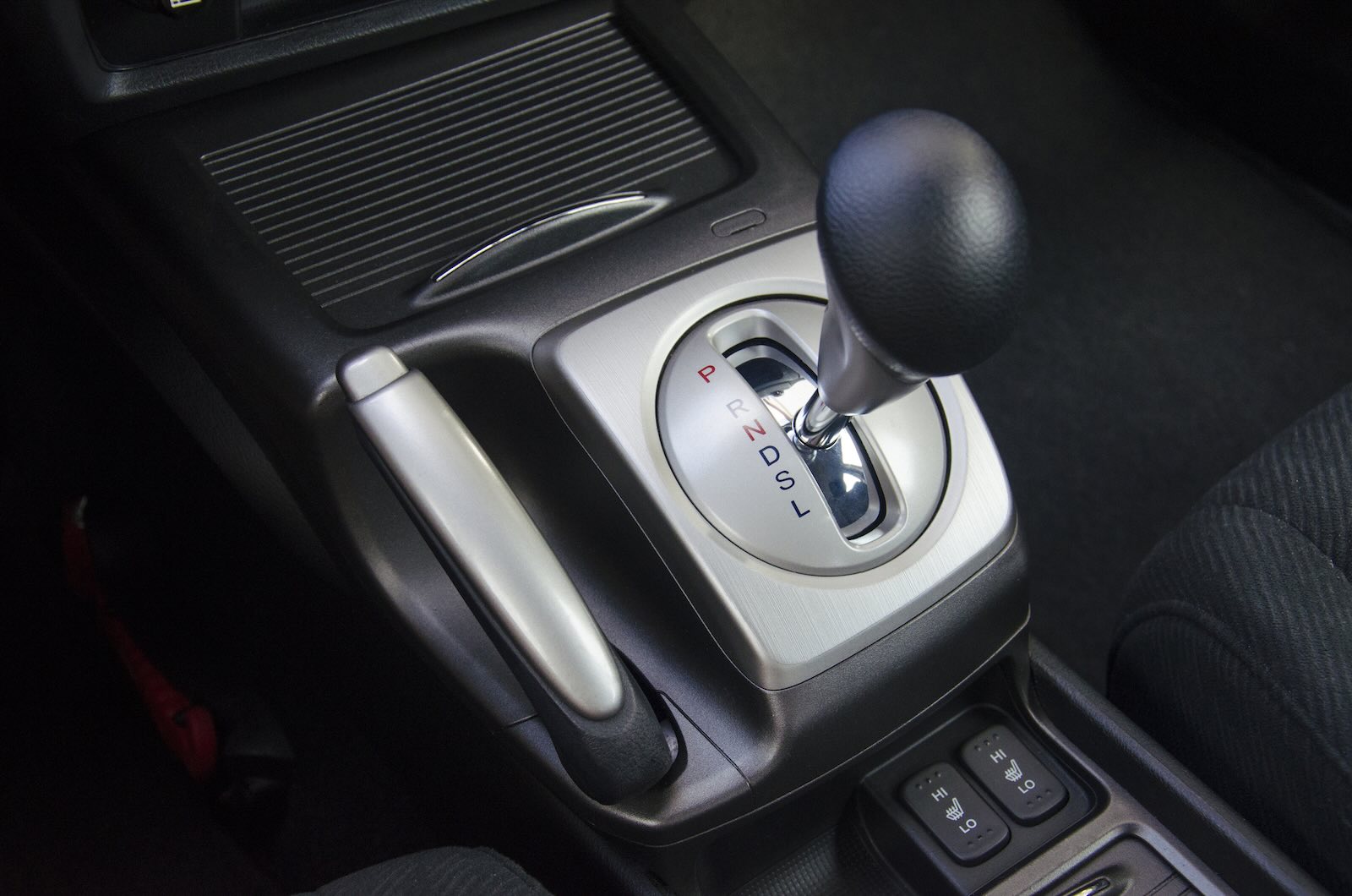The gearshift lever in an automatic transmission car coasting downhill in neutral