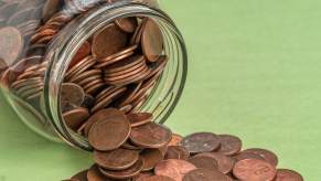 Overturned jar of copper pennies to pay parking ticket.