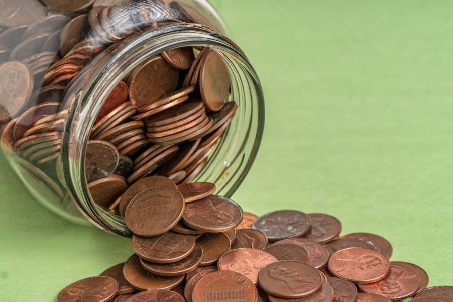 Overturned jar of copper pennies to pay parking ticket.