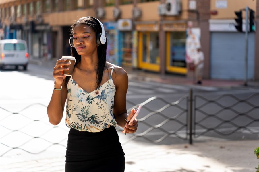 Pedestrian listening to music in headphones on high volume can't hear traffic for safety.