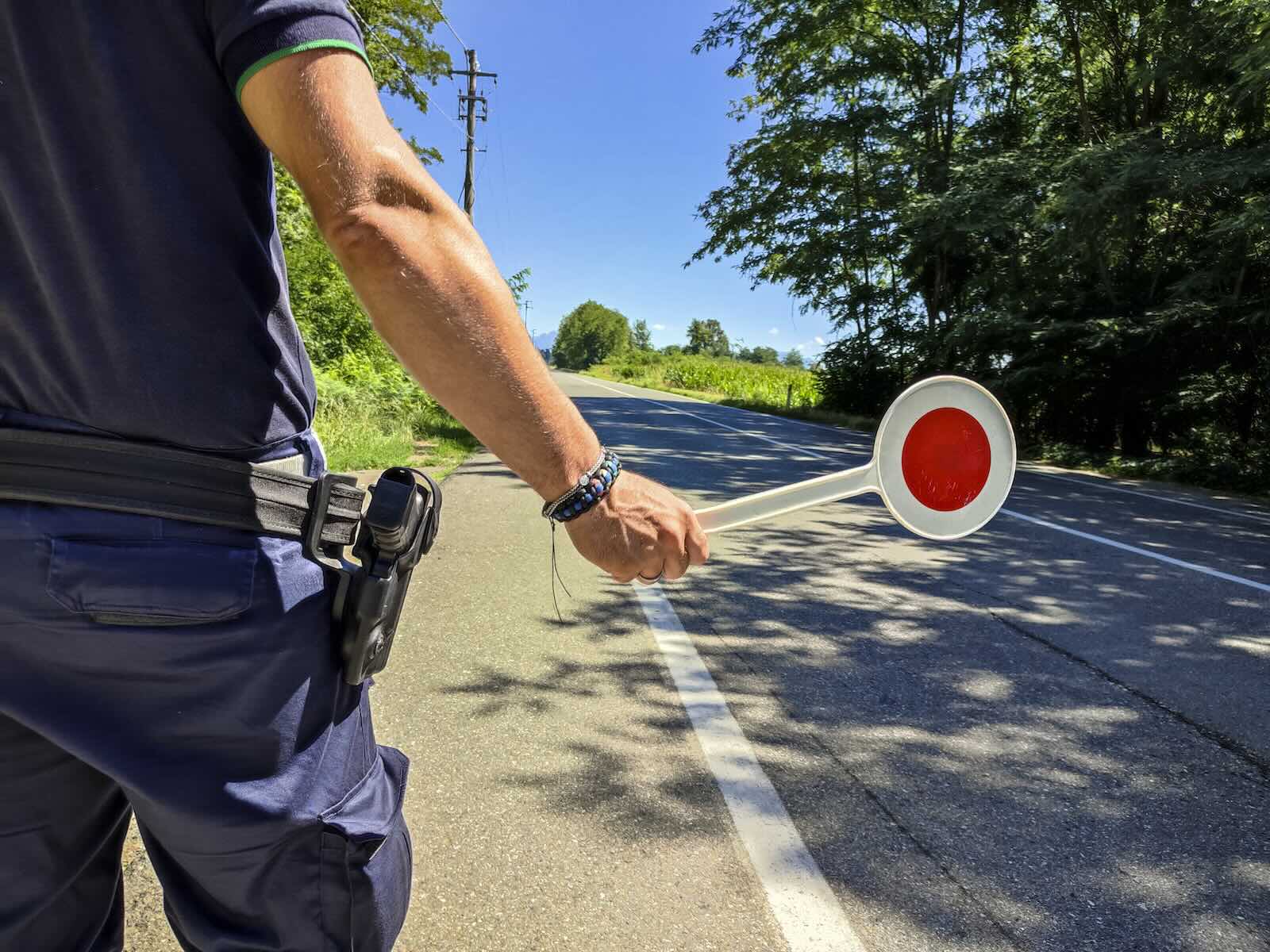 Policeman tracks traffic to set 85% speed limit on a rural road.