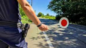 Policeman tracks traffic to set 85% speed limit on a rural road.