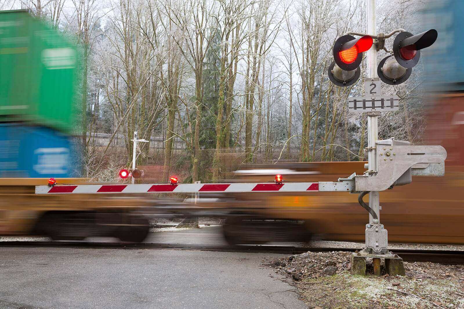 A railroad crossing with train tracks, where police sometimes have to rescue old or distracted drivers.