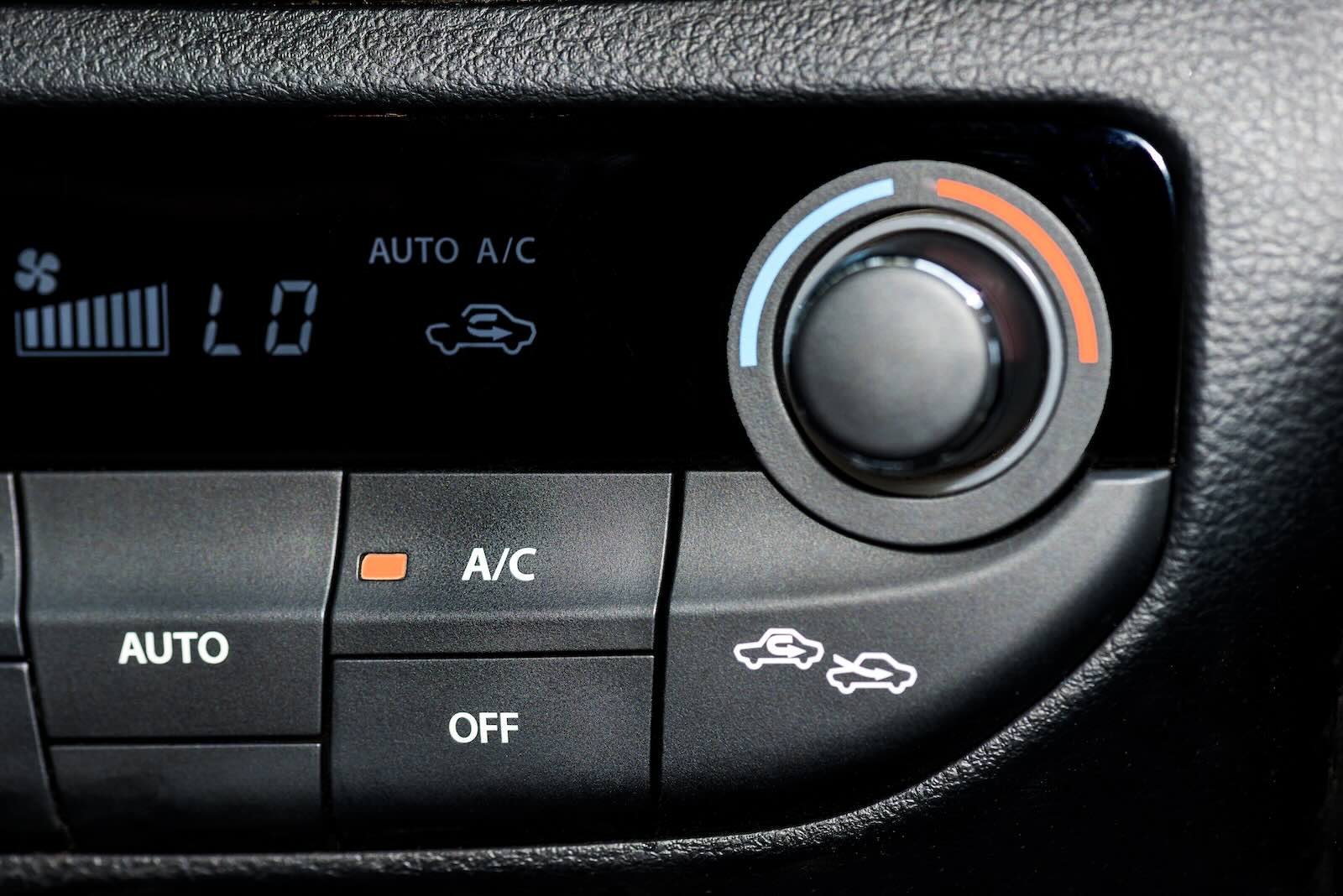 The air recirculation button on a car's A/C / HVAC control panel.