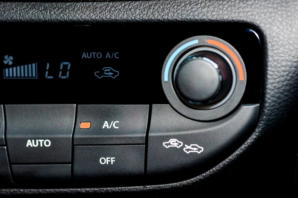 The air recirculation button on a car's A/C / HVAC control panel.