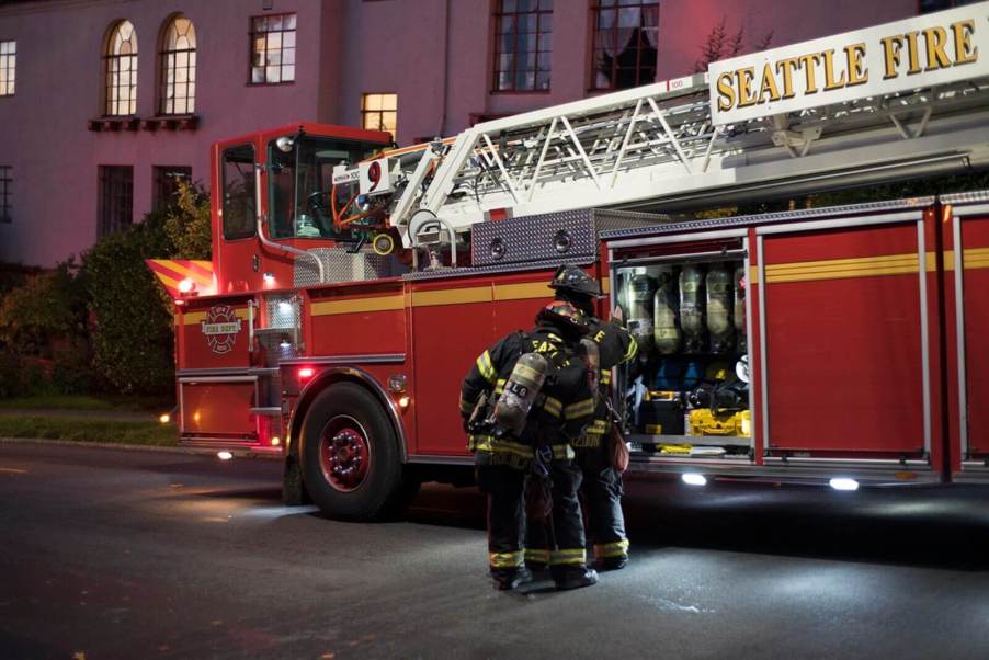 A Seattle Fire Department ladder truck with firefighters.