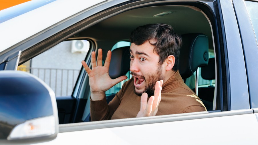 A person screaming in a car