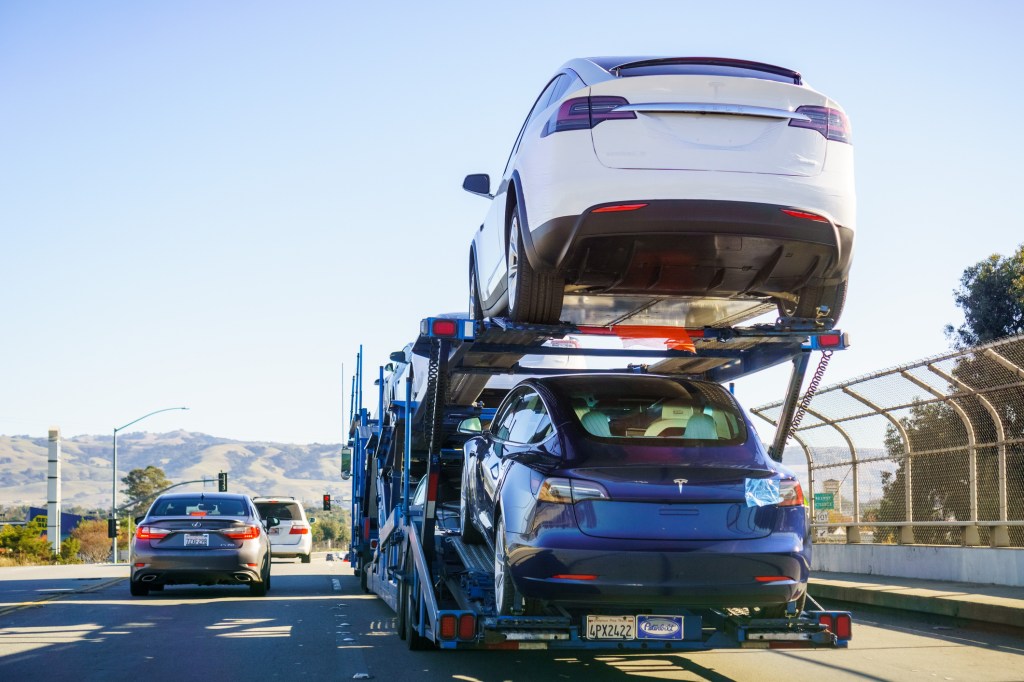 A Car Transporter with Tesla SUVs on the road
