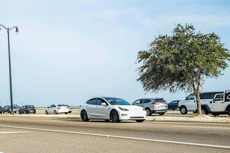 A pre-facelift Tesla Model 3 driving.