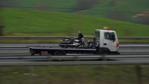 A tow truck hauling a motorcycle