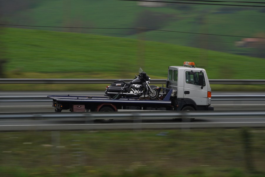 A tow truck hauling a motorcycle