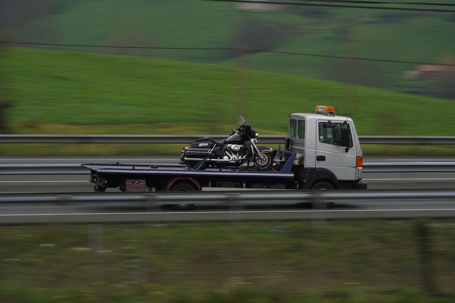 A tow truck hauling a motorcycle