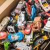 Toy box full of die cast cars from Hot Wheels and Matchbox