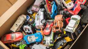 Toy box full of die cast cars from Hot Wheels and Matchbox