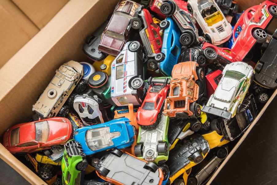 Toy box full of die cast cars from Hot Wheels and Matchbox
