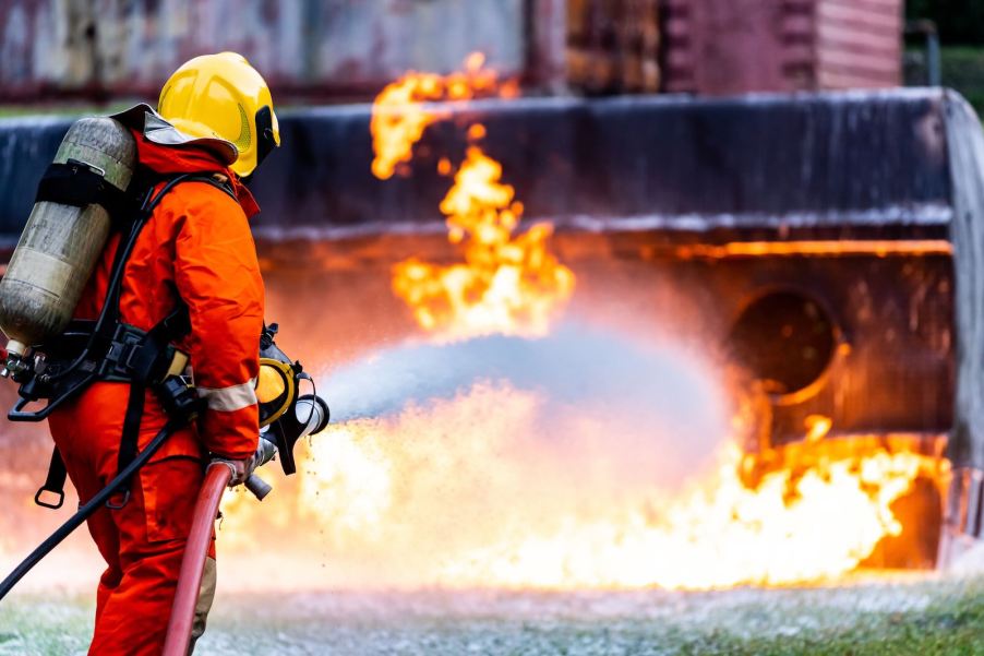 Vegan firefighter uses a hose to put out burning semi truck full of steaks