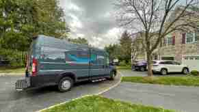 An Amazon Prime delivery van parked on a residential street in right side angle view