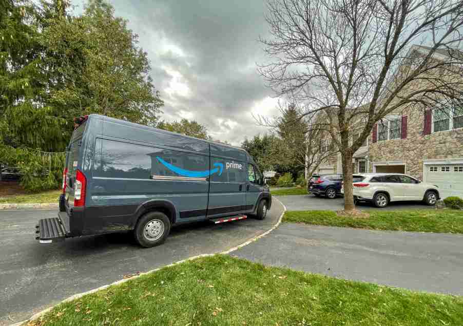 An Amazon Prime delivery van parked on a residential street in right side angle view