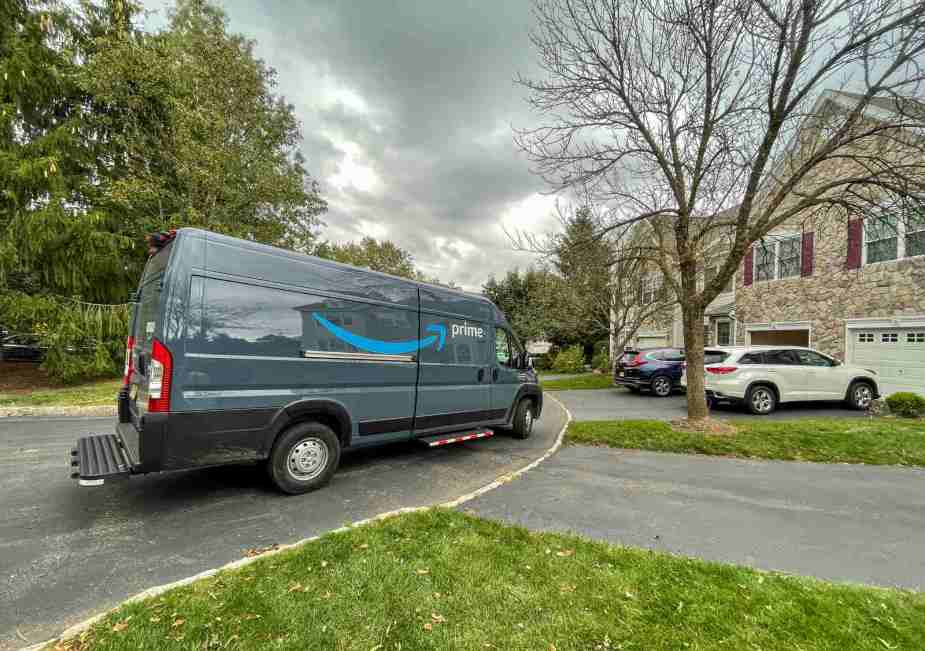 An Amazon Prime delivery van parked on a residential street in right side angle view
