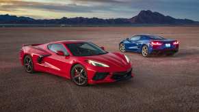 Two Chevrolet Corvette performance cars parked in the desert