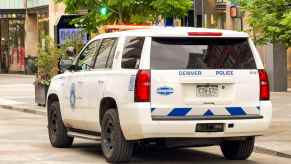 A Denver police SUV parked in left rear angle view