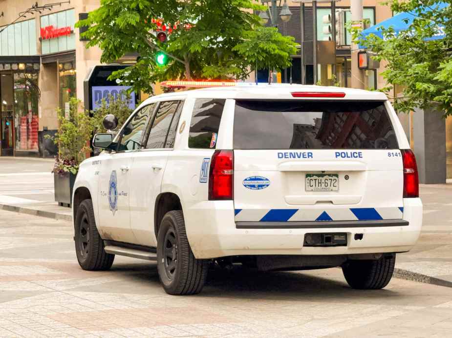 A Denver police SUV parked in left rear angle view