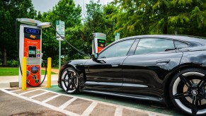 An EV fast charger with a car parked at it