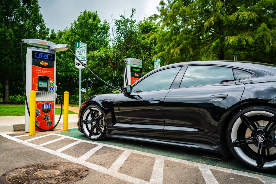 An EV fast charger with a car parked at it