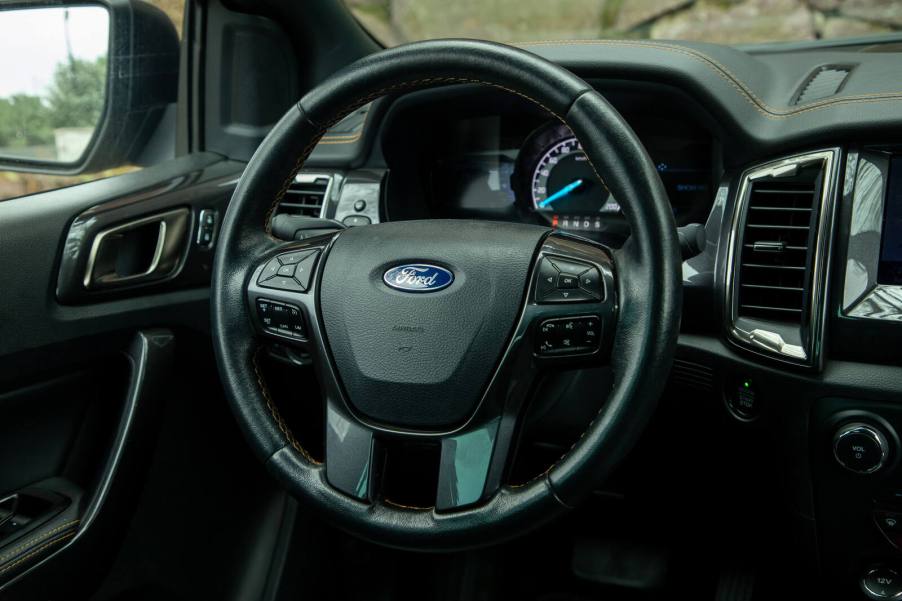 A Ford steering wheel and left front dash view