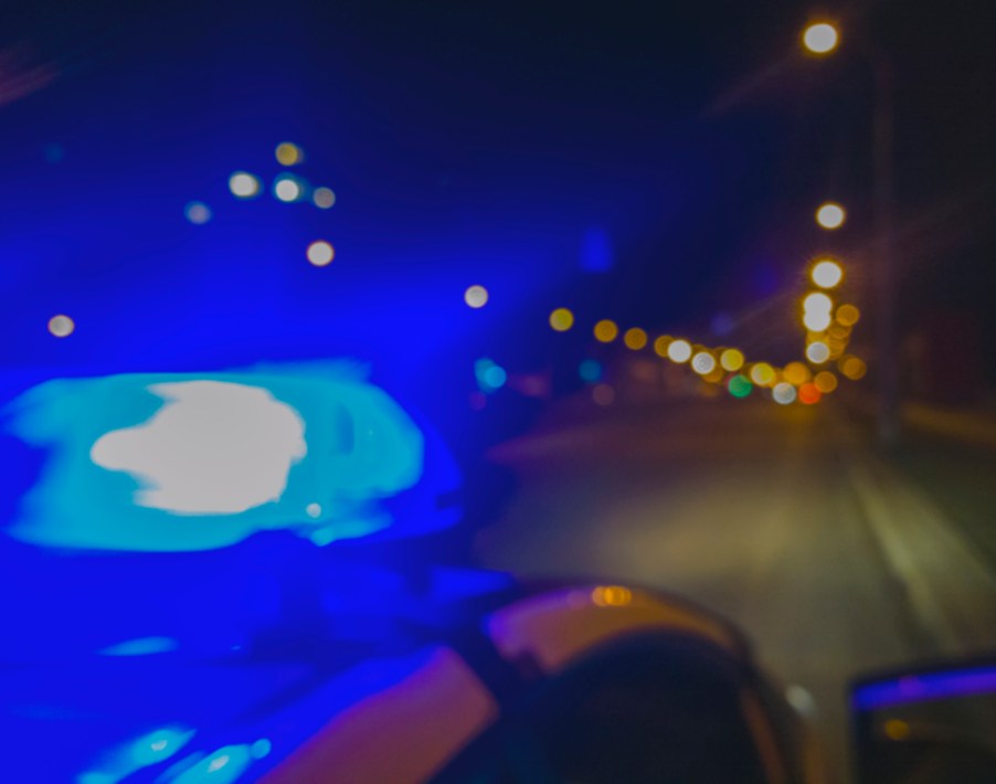 Police car with its lights on at night