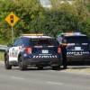 A set of police SUVs at an emergency scene involving inmates.