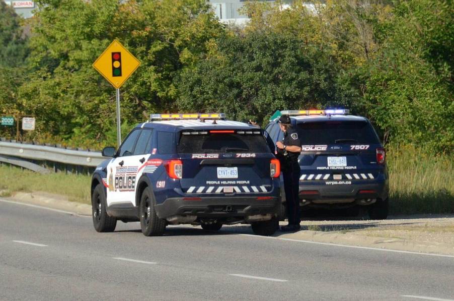 A set of police SUVs at an emergency scene involving inmates.