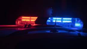 Police cruiser roof lights on at night in very close view