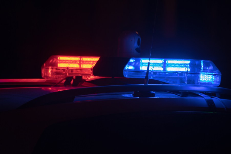 Police cruiser roof lights on at night in very close view