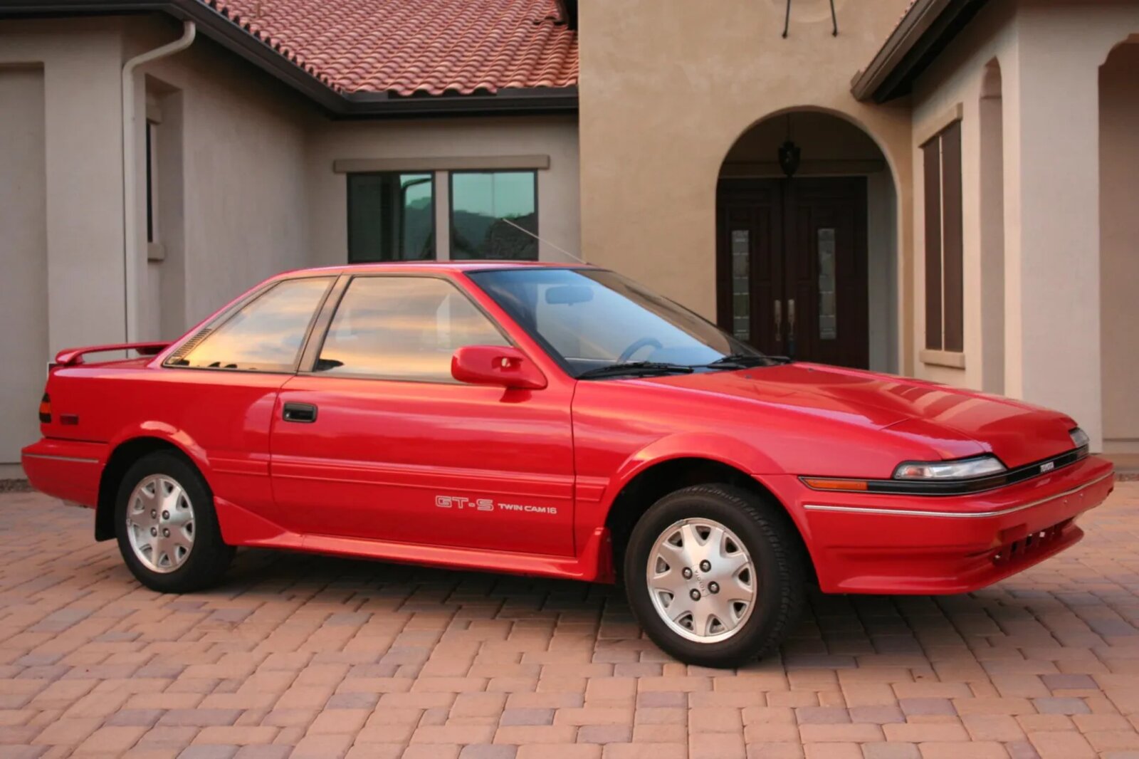 A red 1989 Toyota Corolla GT-S parked in right-angled profile view