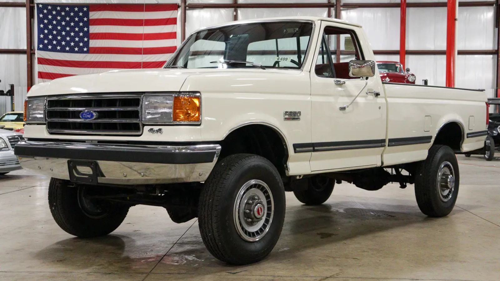 A white 1990 Ford F-350 XLT Lariat 4×4 5-Speed parked in left front angle view