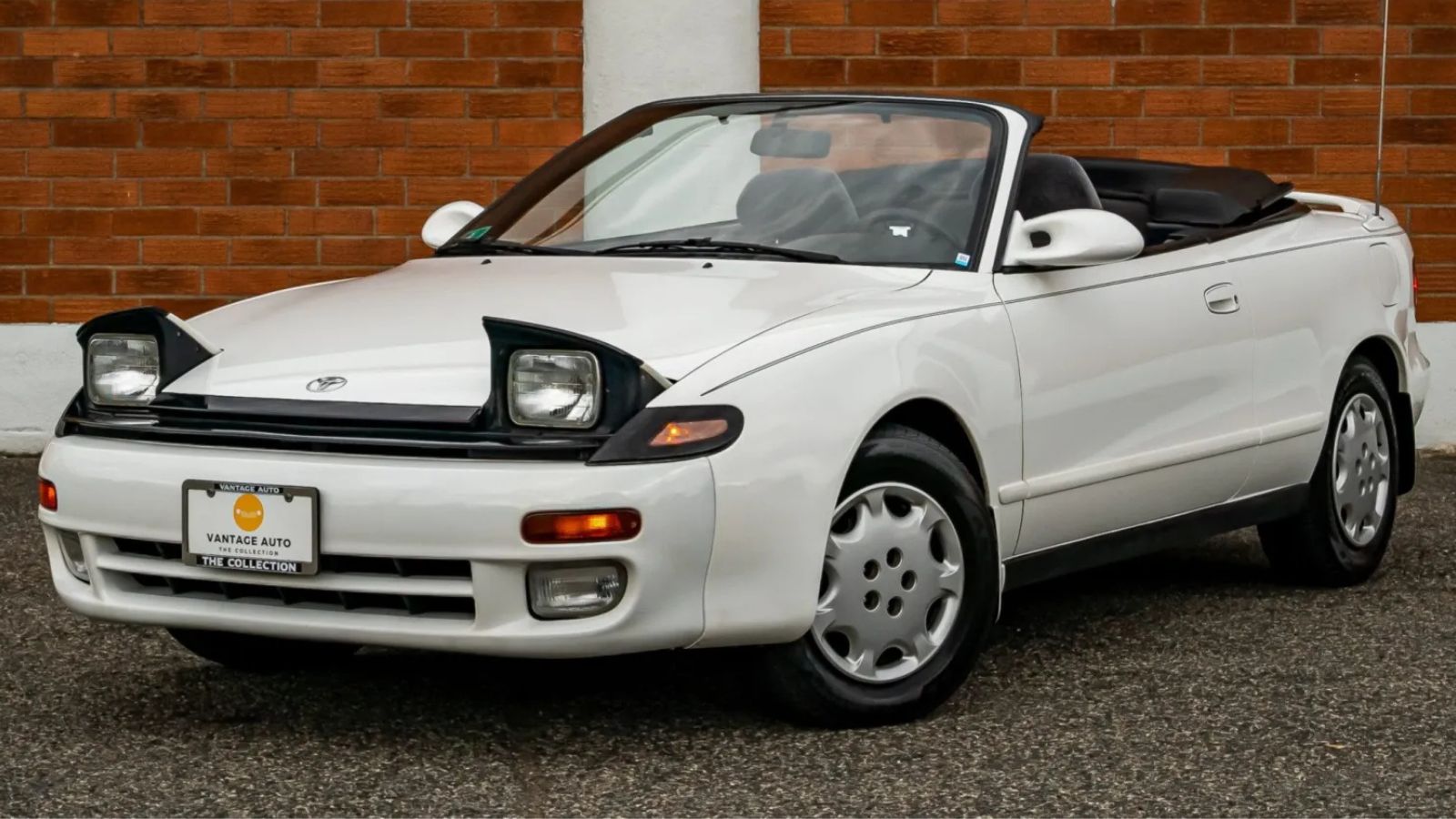 A white 1993 Toyota Celica GT Convertible 5-Speed parked in left front angle view with headlights popped up