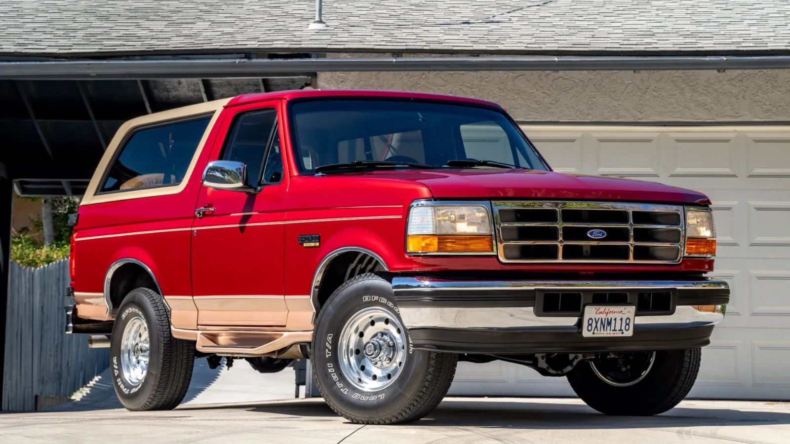A red 1995 Ford Bronco Eddie Bauer parked in right front angle view