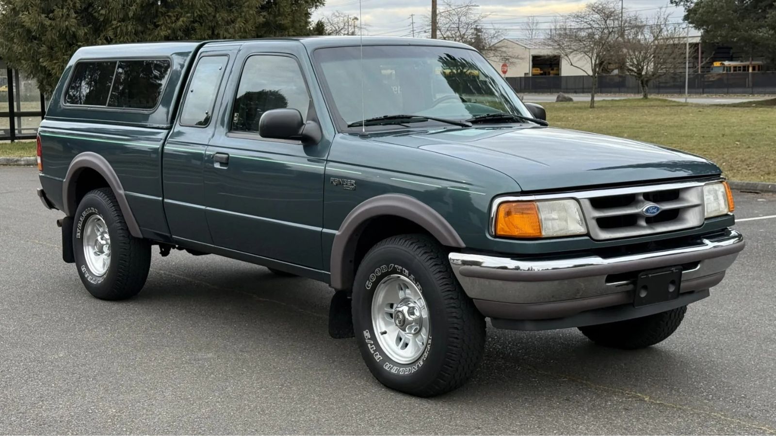 A green 1997 Ford Ranger XLT SuperCab 4×4 4.0L 5-Speed parked in right front angle view