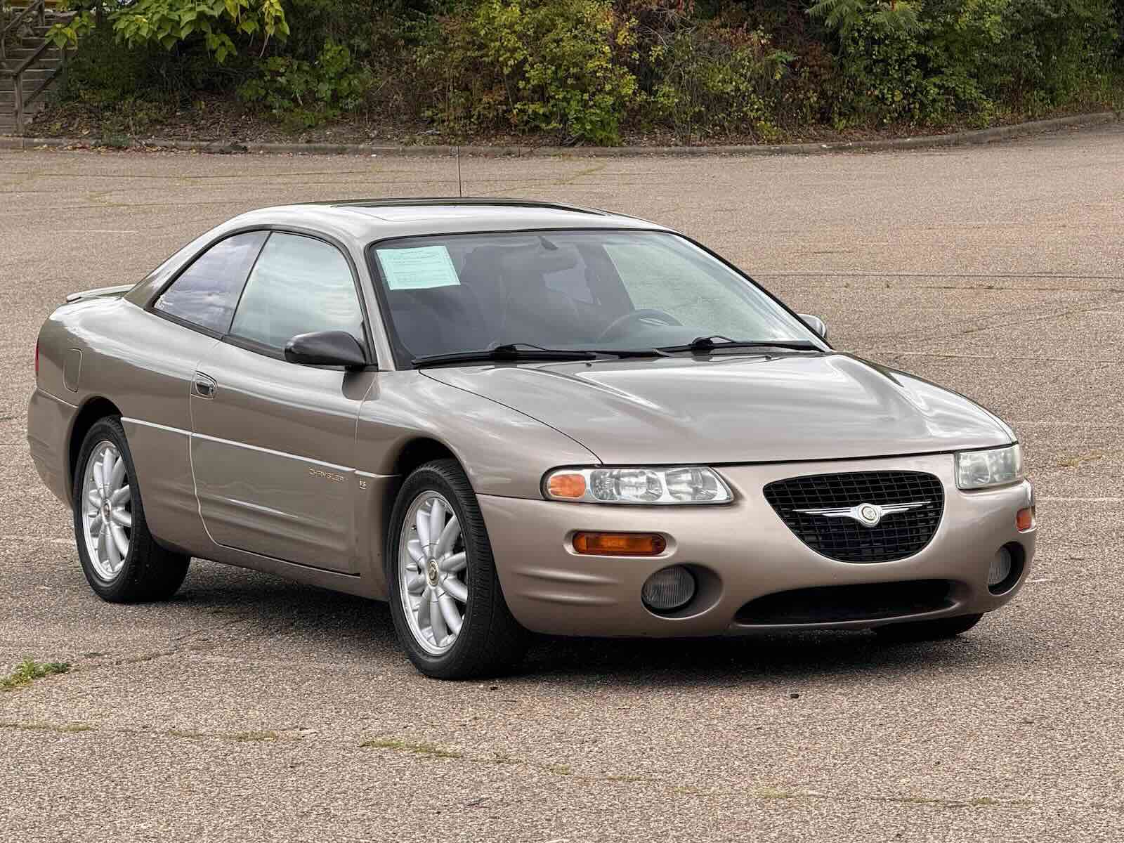 The front of a beige Chrysler Sebring Coupe in a parking lot
