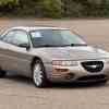 The front of a beige Chrysler Sebring Coupe in a parking lot