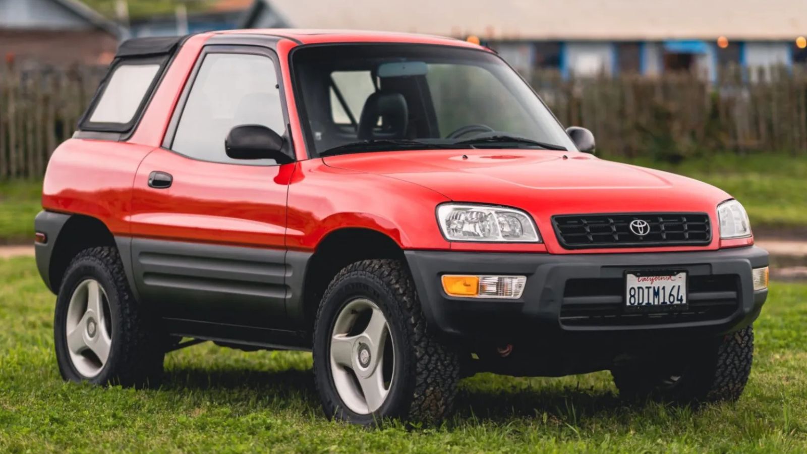 A red 1998 Toyota RAV4 parked in right front angle view