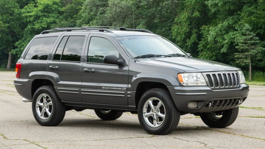 A grey 2002 Jeep Grand Cherokee Overland V8 HO parked in right front angle view